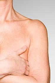 A woman covering her breast